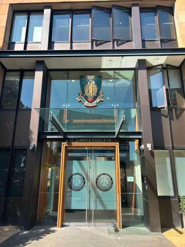 a glass building with a door in front of it at Camperdown Cozy Corner 4 in Sydney