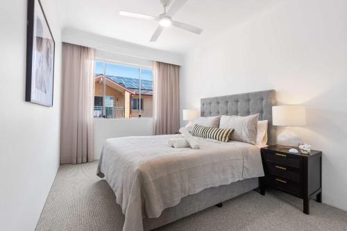 a bedroom with a large bed and a window at Camperdown Cozy Corner 5 in Sydney