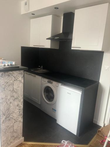 une cuisine avec un lave-linge et un micro-ondes dans l'établissement Flixhouse, à Rouen