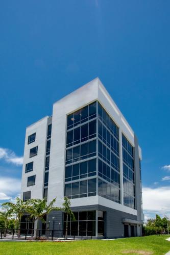 an office building with a lot of windows at Kompose Boutique Miami Airport in Miami