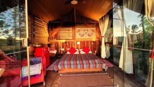 a bedroom with a bed in a wooden room at Ecopousada Toca do Guará in Alto Paraíso de Goiás
