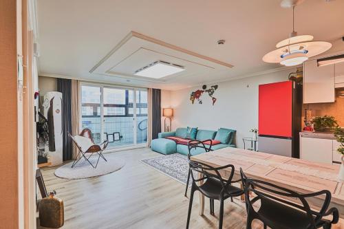 a kitchen and living room with a table and chairs at Haeundae Beach Bexco in Busan