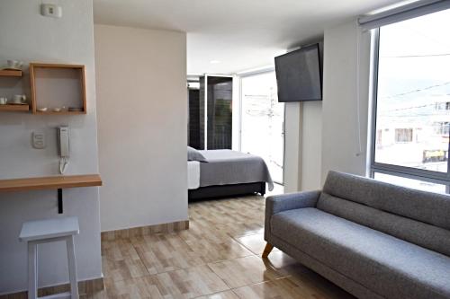 a living room with a couch and a bed at Villa Quintero202 in Santa Rosa de Cabal