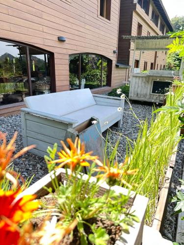 a barbecue grill sitting outside of a house with flowers at Le Bouquet Apart Hotel in San Carlos de Bariloche