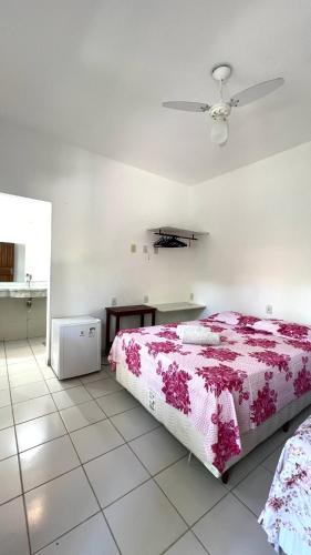 a bedroom with a bed and a ceiling fan at Morada Pedra da Lua in Porto Seguro