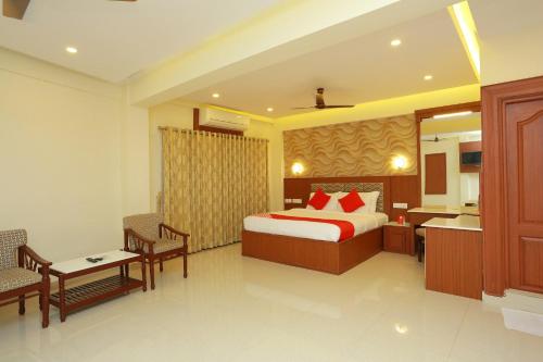 a hotel room with a bed and a kitchen at Super Capital O Kovilakam Residency in Trichūr