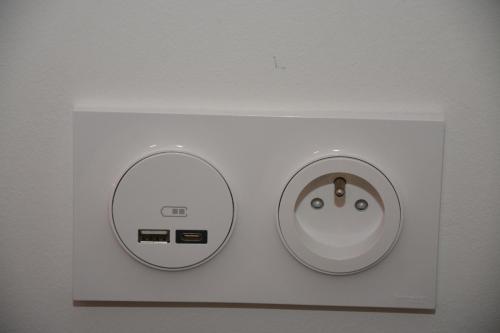 a white box with two buttons on a wall at Maison Jacob - Hyper centre - Maison historique - Air conditioning - Wifi in Avignon