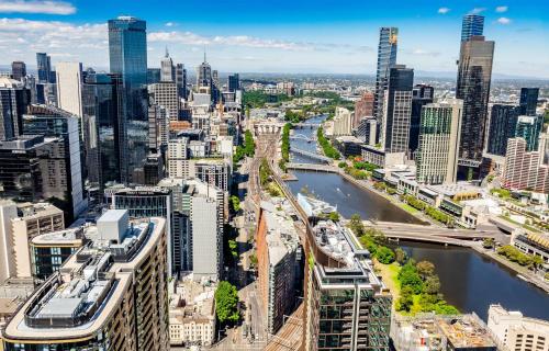 an aerial view of a city with a river and buildings at Pars apartments - Melbourne Quarter- unique View of city and Yarra in Melbourne