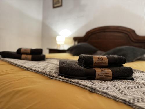 a group of towels laying on top of a bed at El Desván del Trigo in El Barraco