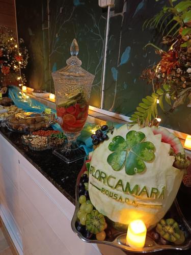 a table with a display of food and a candle at Florcamará POUSADA in Camaragibe