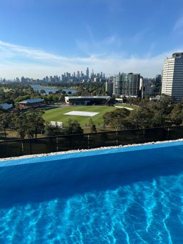 a swimming pool with a view of the city at St Kilda Fitzroy St apt in secure luxury building in Melbourne