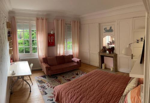 a bedroom with a bed and a chair and a mirror at Equilibrium Family House by E in Roubaix