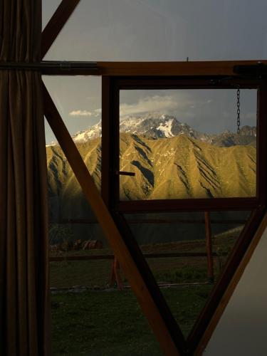 a view of a mountain through a window at Memorable Sacred Experienced in Cusco