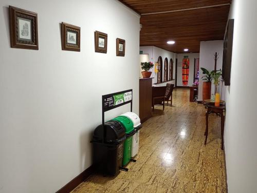 a hallway of a house with a trash can on the floor at Hotel Alpino Armenia in Armenia