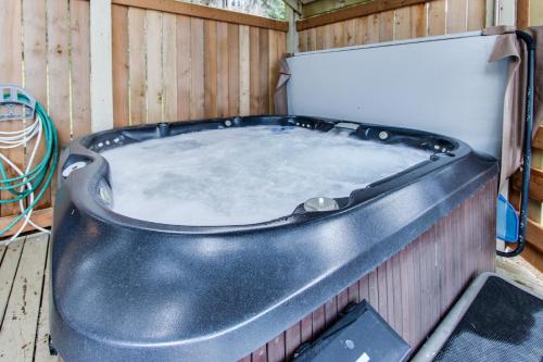 a bath tub sitting inside of a wooden fence at Haystack Views Vacation Rental in Cannon Beach