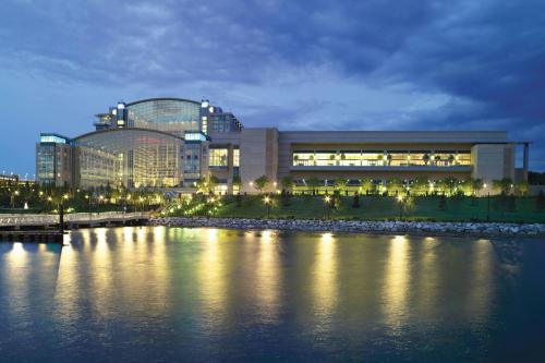 a large building next to a body of water at night at Gaylord National Resort & Convention Center in National Harbor