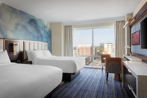 a hotel room with two beds and a window at Gaylord National Resort & Convention Center in National Harbor
