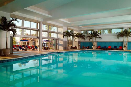 a large swimming pool in a hotel with palm trees at Gaylord National Resort & Convention Center in National Harbor