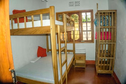 a room with two bunk beds and a window at Moshi hostel lodge in Msaranga