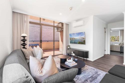 a living room with a couch and a table at Camperdown Cozy Corner 6 in Sydney