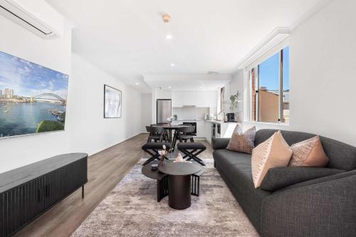 a living room with a couch and a table at Camperdown Cozy Corner 6 in Sydney