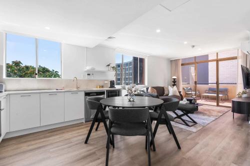 a kitchen and living room with a table and chairs at Camperdown Cozy Corner 6 in Sydney