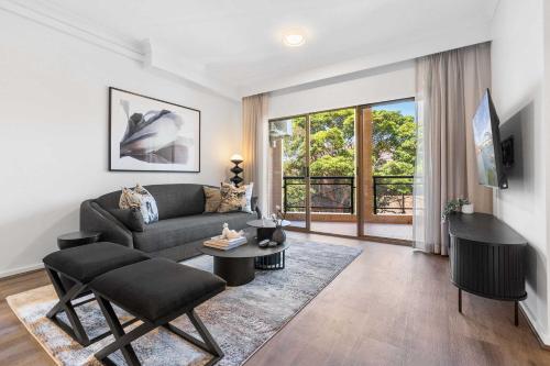 a living room with a couch and a table at Camperdown Cozy Corner 7 in Sydney