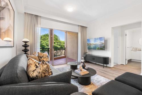 a living room with a couch and a television at Camperdown Cozy Corner 7 in Sydney