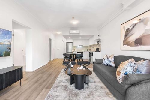 a living room with a couch and a table at Camperdown Cozy Corner 7 in Sydney