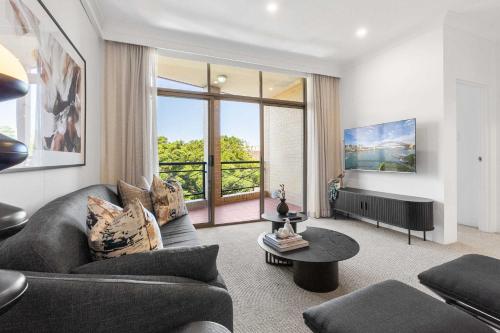 a living room with a couch and a table at Camperdown Cozy Corner 8 in Sydney