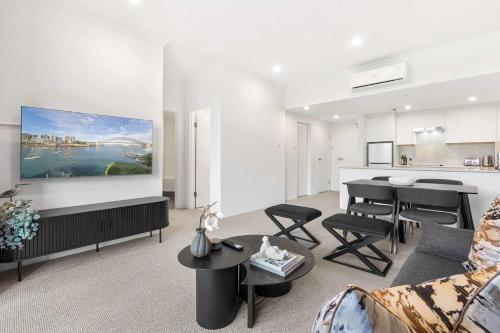 a living room with a couch and a table at Camperdown Cozy Corner 8 in Sydney