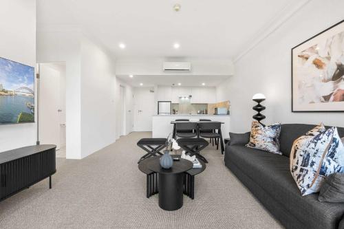 a living room with a couch and a table at Camperdown Cozy Corner 8 in Sydney