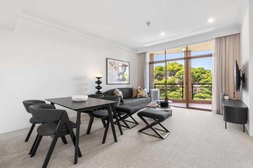 a living room with a table and chairs and a couch at Camperdown Cozy Corner 8 in Sydney