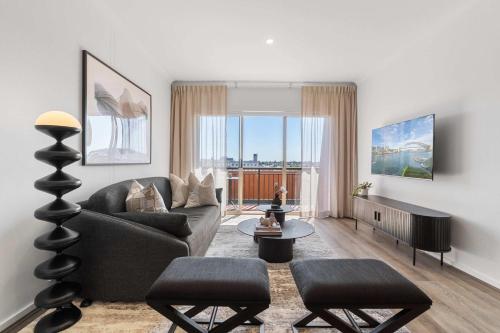 a living room with a couch and a table at Camperdown Cozy Corner 10 in Sydney
