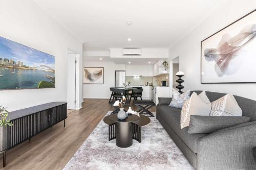 a living room with a couch and a table at Camperdown Cozy Corner 10 in Sydney