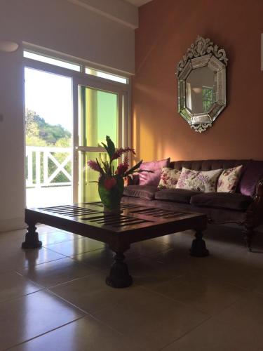 a living room with a couch and a table at Beautiful apartment with pool & sea views, Mero in Méro