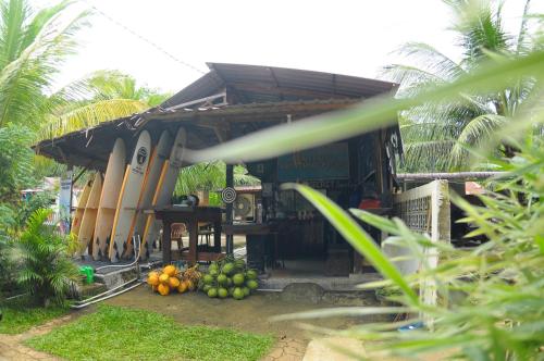 a building with a bunch of fruit in front of it at Air Manis Secret Surfcamp in Taluk Batung