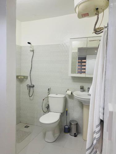 a bathroom with a toilet and a sink at Furnished studio in Mermoz in Dakar