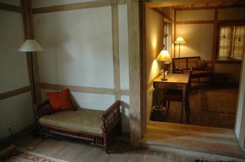 a room with a chair and a table with a lamp at Serena Khaplu Palace in Khaplu