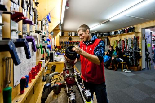 a man standing in a store with a helmet on a bike at Ferienwohnung Ski-Hans in Planneralm