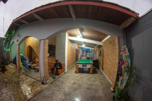 an archway in a building with a pool table at CASA 51 HOSTEL ubatuba in Ubatuba
