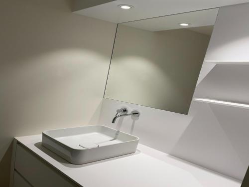 a bathroom with a sink and a mirror at Apartment in Groede near the Beach in Groede