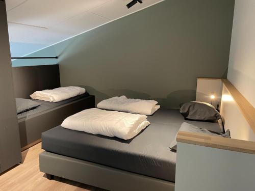 two beds in a room with a room with a bedvisor at Apartment in Groede near the Beach in Groede