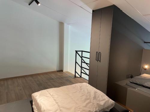 a bedroom with a bed and a staircase in it at Apartment in Groede near the Beach in Groede