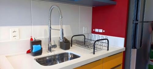 a kitchen with a sink and a faucet at Apto, Moderno - perto da WEG in Jaraguá do Sul