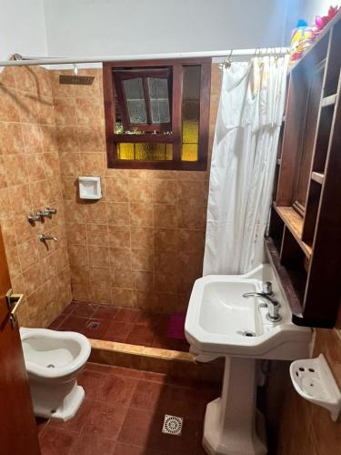 a bathroom with a toilet and a sink at Mar y Sierras in La Paz
