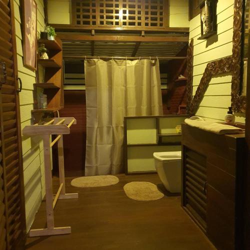 a bathroom with a shower curtain and a toilet at Sandy Lake 2012 in Kaeng Krachan