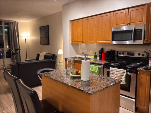 a kitchen with a kitchen island with a counter top at A lovely one bed room with Sunset Views in Toronto