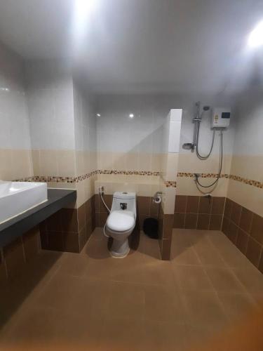 a bathroom with a toilet and a sink at Ingfah Mountainview in Hat Yai