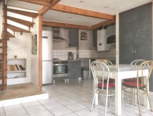 - une cuisine avec une table et des chaises blanches dans l'établissement Appartement charmant à Nice / 50 m² / Vue sur la ville, à Nice